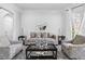 Bright living room features neutral paint, a decorative mirror, and comfortable seating for entertaining at 2616 Boddie Pl, Duluth, GA 30097