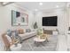 Bright living room with stylish decor, a comfortable sofa, modern art, and large windows at 2616 Boddie Pl, Duluth, GA 30097
