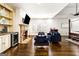 Open-concept living space showcasing a stone fireplace, built-in shelving, and plenty of seating at 2616 Boddie Pl, Duluth, GA 30097