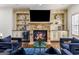 Charming living room featuring a stone fireplace, built-in shelving, and comfortable seating at 2616 Boddie Pl, Duluth, GA 30097