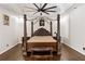 This main bedroom features a tray ceiling, ceiling fan, hardwood floors, and a four-poster bed at 2616 Boddie Pl, Duluth, GA 30097