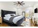 Bright main bedroom with a ceiling fan and a terrace with french doors and decorative rug at 2616 Boddie Pl, Duluth, GA 30097