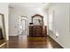 Main bedroom has a wooden dresser with a decorative mirror, hardwood floors, and white trim at 2616 Boddie Pl, Duluth, GA 30097