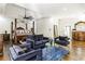 Relaxing main bedroom boasts a tray ceiling, four-poster bed, sitting area and hardwood floors at 2616 Boddie Pl, Duluth, GA 30097