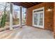 Covered patio with brick columns, brick accent wall, and a wood ceiling at 2616 Boddie Pl, Duluth, GA 30097