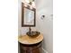 Charming powder room featuring a decorative vessel sink, custom vanity, and stylish fixtures enhancing its unique design at 2616 Boddie Pl, Duluth, GA 30097