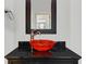 Elegant powder room featuring a unique vessel sink, dark countertop, and modern fixtures, offering a touch of luxury at 2616 Boddie Pl, Duluth, GA 30097