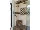 Close-up of frameless shower with marble seat, shower head, and mosaic tile design at 2616 Boddie Pl, Duluth, GA 30097