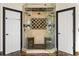 This frameless shower features tile walls, a marble seat, multiple shower heads and tile flooring at 2616 Boddie Pl, Duluth, GA 30097