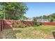 Large, grassy backyard with a privacy fence, mature trees and lush landscaping at 2686 Oak Leaf Se Pl, Atlanta, GA 30316