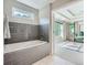 Bathroom with gray tile accent wall and bathtub at 2686 Oak Leaf Se Pl, Atlanta, GA 30316