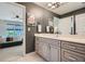 Bathroom with a modern vanity, large mirror and door leading to bedroom at 2686 Oak Leaf Se Pl, Atlanta, GA 30316
