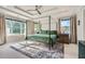 Bright bedroom features a canopy bed, tray ceiling, large windows and neutral decor at 2686 Oak Leaf Se Pl, Atlanta, GA 30316