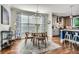 Dining area featuring hardwood floors, modern lighting, and natural light from the large window at 2686 Oak Leaf Se Pl, Atlanta, GA 30316