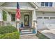 Charming front porch with stone pillars, American flag, and a well-manicured garden at 2686 Oak Leaf Se Pl, Atlanta, GA 30316