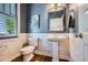 Stylish half-bath with marble wainscoting, dark blue accent wall, and modern fixtures at 2686 Oak Leaf Se Pl, Atlanta, GA 30316