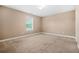 Neutral bedroom with natural light from the window creates a serene and inviting space at 4616 Town Manor Dr, Douglasville, GA 30135