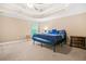 Spacious bedroom featuring a ceiling fan, tray ceiling, and large window with natural light at 4616 Town Manor Dr, Douglasville, GA 30135
