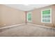 Well-lit bedroom featuring two windows, offering a bright and airy ambiance for relaxation and comfort at 4616 Town Manor Dr, Douglasville, GA 30135