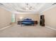 Spacious bedroom featuring tray ceiling, fan, and carpet with window offering natural light at 4616 Town Manor Dr, Douglasville, GA 30135
