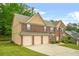 Spacious brick home with a three-car garage and well-maintained lawn at 4616 Town Manor Dr, Douglasville, GA 30135
