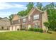 Beautiful brick home with a three-car garage, green lawn, and trimmed hedges at 4616 Town Manor Dr, Douglasville, GA 30135