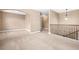 Hallway with carpet and decorative lights, featuring a second story wrought iron railing at 4616 Town Manor Dr, Douglasville, GA 30135