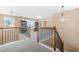 Hallway showcasing wrought iron railing and views of built-in bookshelves on the second floor at 4616 Town Manor Dr, Douglasville, GA 30135