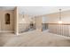 Carpeted hallway with wrought iron railing, offering views of downstairs area and multiple rooms at 4616 Town Manor Dr, Douglasville, GA 30135