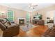 Inviting living room featuring a fireplace, hardwood floors, and comfortable seating at 4616 Town Manor Dr, Douglasville, GA 30135