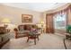 Cozy living room featuring plush seating, carpeted floors, and natural light at 4616 Town Manor Dr, Douglasville, GA 30135
