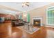 Open-concept living room with a fireplace, hardwood floors, and ample natural light at 4616 Town Manor Dr, Douglasville, GA 30135
