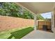 Backyard view with a new patio, grass and a privacy fence on a lot with a grade at 4667 Larkfield Way, Powder Springs, GA 30127