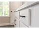 Close-up of bathroom cabinet with black hardware and trim and large window offering natural light at 4667 Larkfield Way, Powder Springs, GA 30127