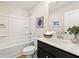Clean bathroom with a white shower-tub combo, modern vanity, and stylish decor creating a peaceful ambiance at 4667 Larkfield Way, Powder Springs, GA 30127