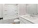 Bright bathroom featuring white fixtures and modern design with a shower over tub and vanity sink at 4667 Larkfield Way, Powder Springs, GA 30127