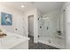 Bathroom featuring a walk-in shower with glass door and modern fixtures at 4667 Larkfield Way, Powder Springs, GA 30127