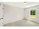 Cozy bedroom with plush carpeting, closet, and window overlooking greenery at 4667 Larkfield Way, Powder Springs, GA 30127