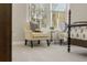 Bright bedroom corner featuring armchairs and natural light from a large window at 4667 Larkfield Way, Powder Springs, GA 30127