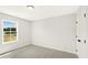 Bedroom with plush carpeting, a window with a view, and white walls at 4667 Larkfield Way, Powder Springs, GA 30127