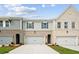 Charming townhomes with brick and gray siding, featuring attached garages and well-manicured lawns at 4667 Larkfield Way, Powder Springs, GA 30127