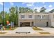 Daytime view of new townhome with brick accents, two-car garage, and attractive landscaping in a suburban setting at 4667 Larkfield Way, Powder Springs, GA 30127