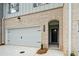 Townhome with brick and gray siding, featuring an attached garage and a cozy front entrance at 4667 Larkfield Way, Powder Springs, GA 30127