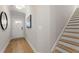 Bright entryway features wood floors, stairs to the upper level, and a white front door at 4667 Larkfield Way, Powder Springs, GA 30127
