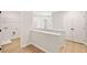 Upstairs hallway with bright white trim, and access to closets and laundry room at 4667 Larkfield Way, Powder Springs, GA 30127