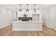 Modern kitchen with quartz countertops, white cabinets, stainless steel appliances, and a kitchen island at 4667 Larkfield Way, Powder Springs, GA 30127