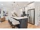 Bright kitchen with stainless steel appliances and a large center island with seating at 4667 Larkfield Way, Powder Springs, GA 30127