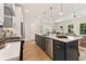 Open concept kitchen with a large island, stainless steel appliances, and a breakfast bar at 4667 Larkfield Way, Powder Springs, GA 30127