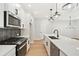 Bright kitchen with white cabinets, stainless steel appliances, a kitchen island and hardwood floors at 4667 Larkfield Way, Powder Springs, GA 30127