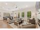 Bright living room with a fireplace, ceiling fan, and hardwood floors at 4667 Larkfield Way, Powder Springs, GA 30127